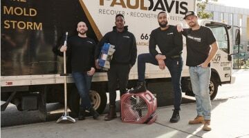 Paul Davis Restoration of Pasadena team members standing beside a service truck with restoration equipment